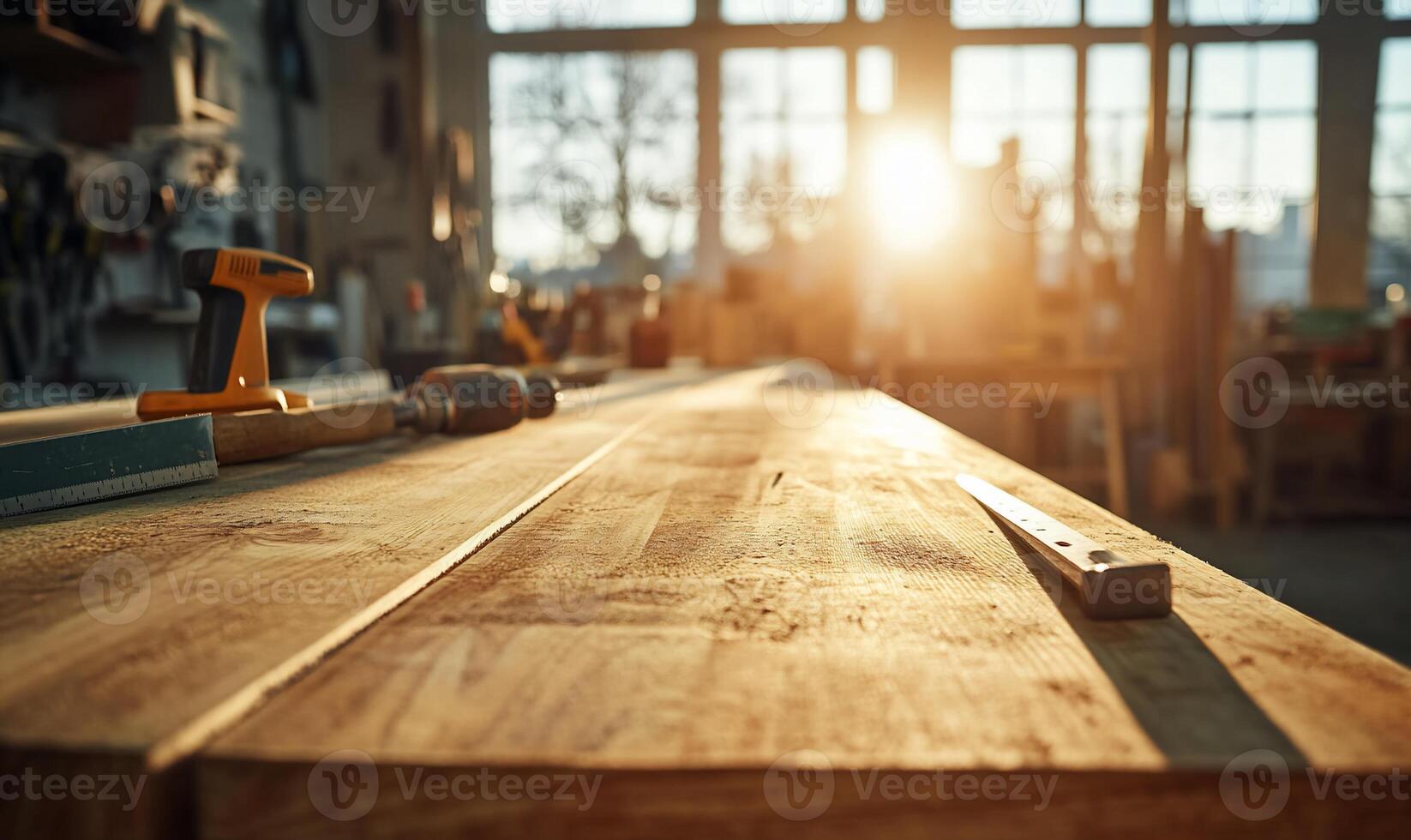 A sunlit workshop with tools on a wooden workbench. photo