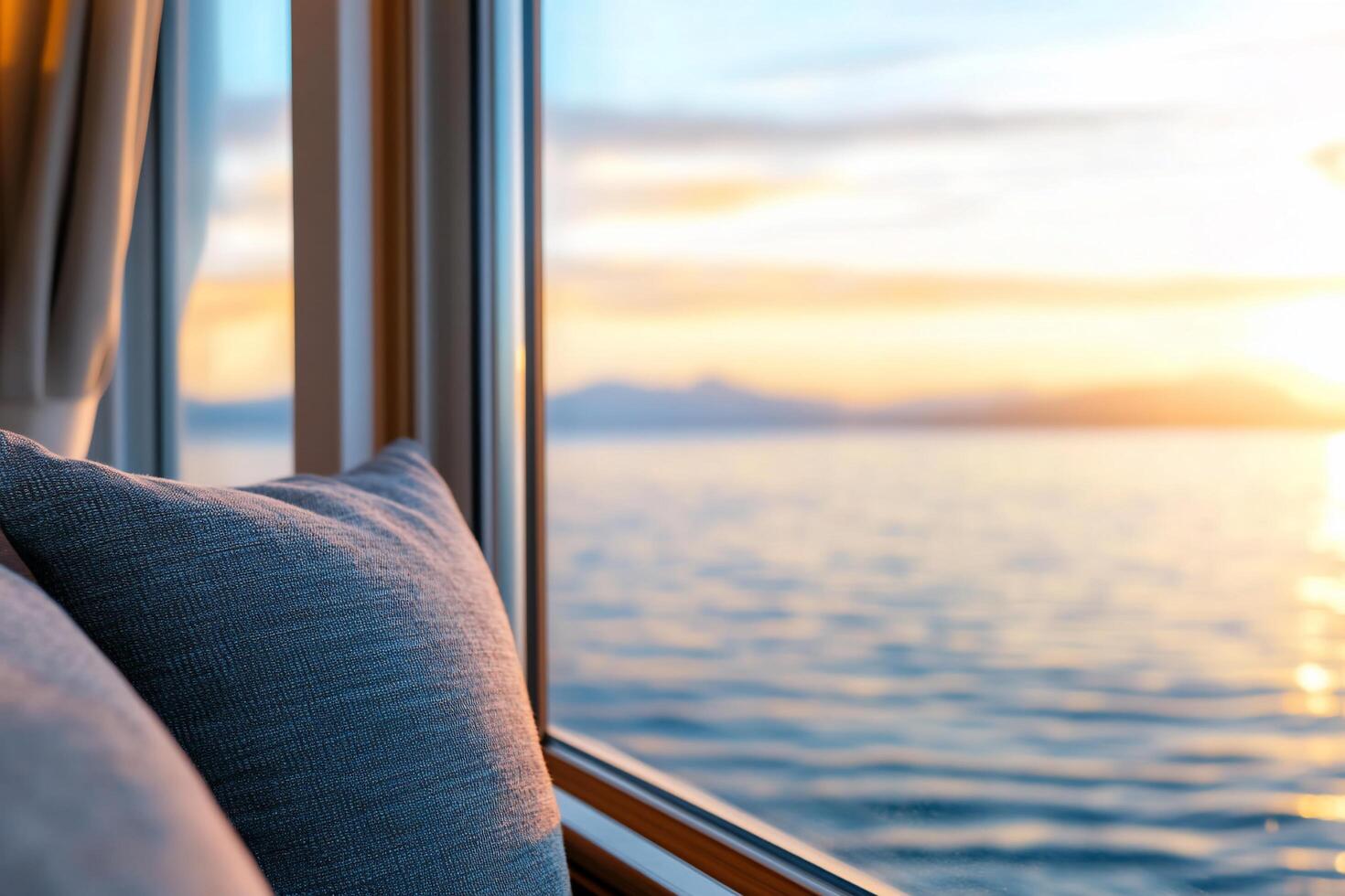 Cozy interior view of a sunset over calm water from a window. photo