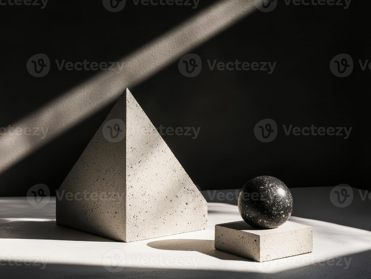 Minimalist Geometric Shapes in Natural Light with Concrete Pyramid and Sphere on White Surface photo