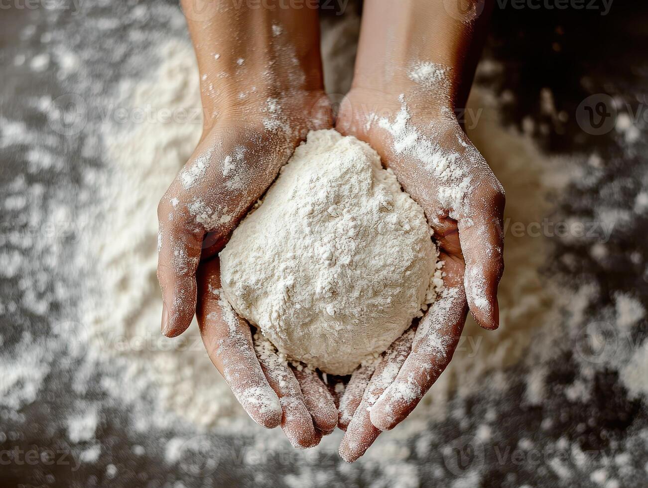 Hands Holding Dough Ball Covered in Flour on a Rustic Kitchen Countertop photo
