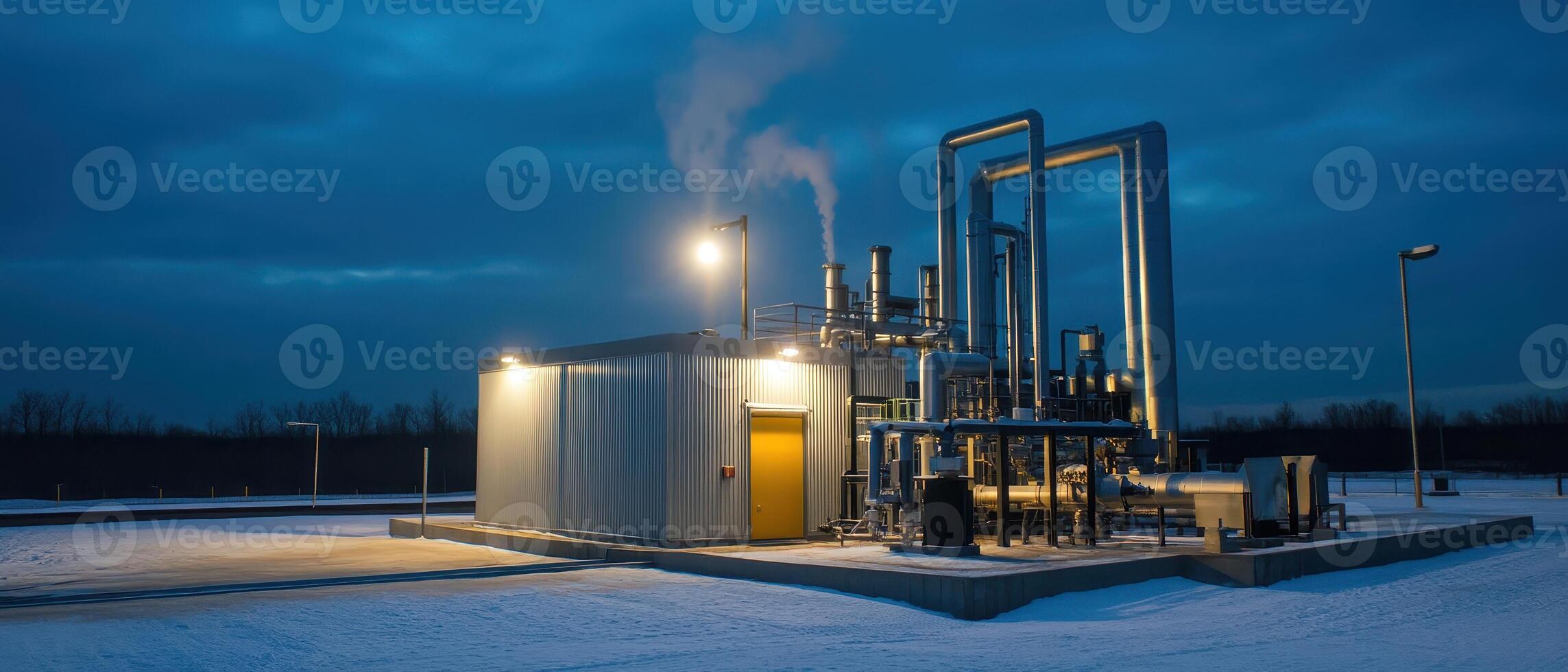 A modern industrial facility emits steam at dusk, surrounded by snow, highlighting its operational efficiency in a cold environment. photo