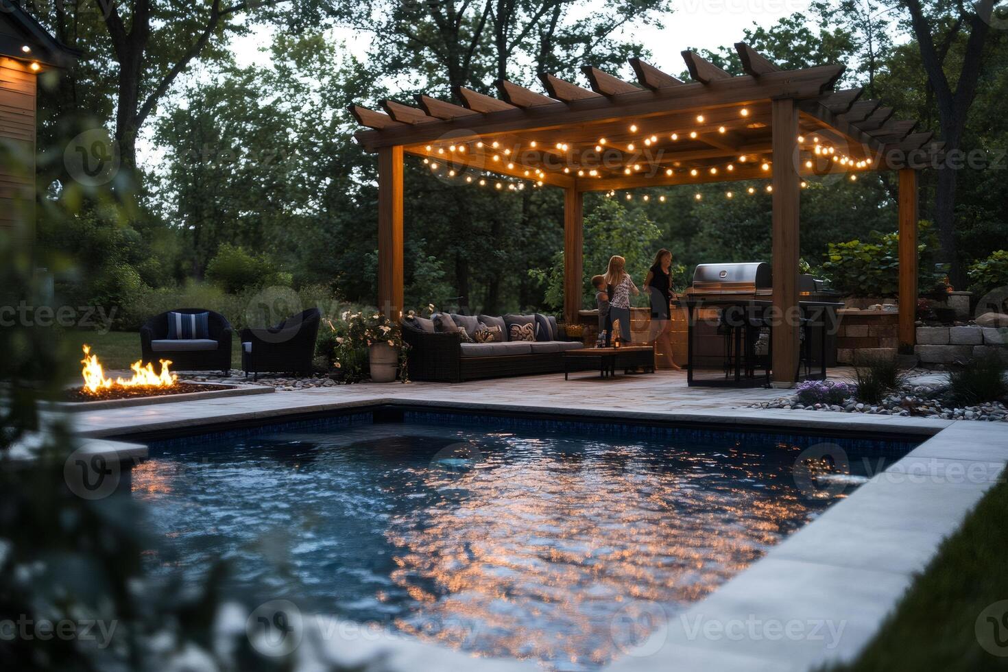 Family enjoying evening by the pool under pergola with lights photo