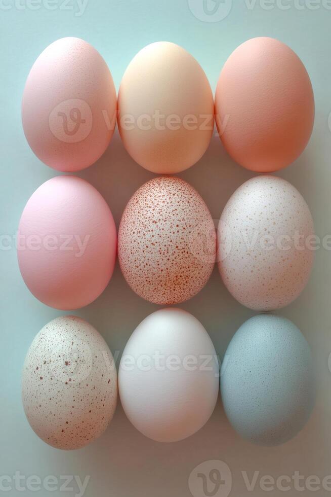 Nine colorful easter eggs forming a square on a light blue background photo
