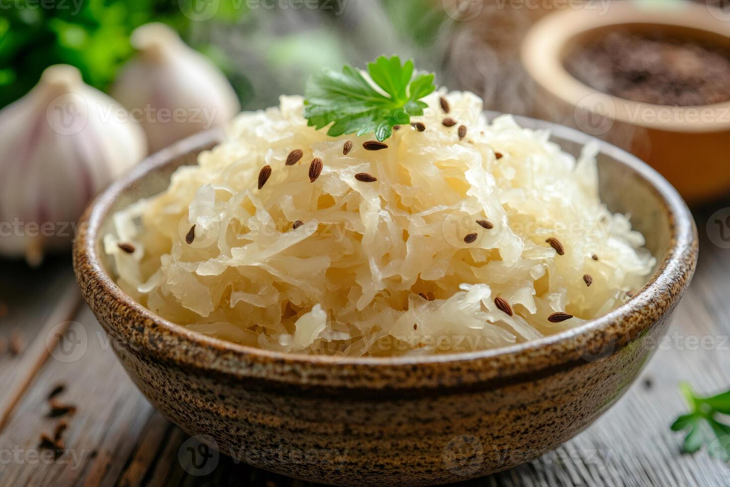 Steaming sauerkraut with caraway seeds and parsley in ceramic bowl is waiting to be eaten photo