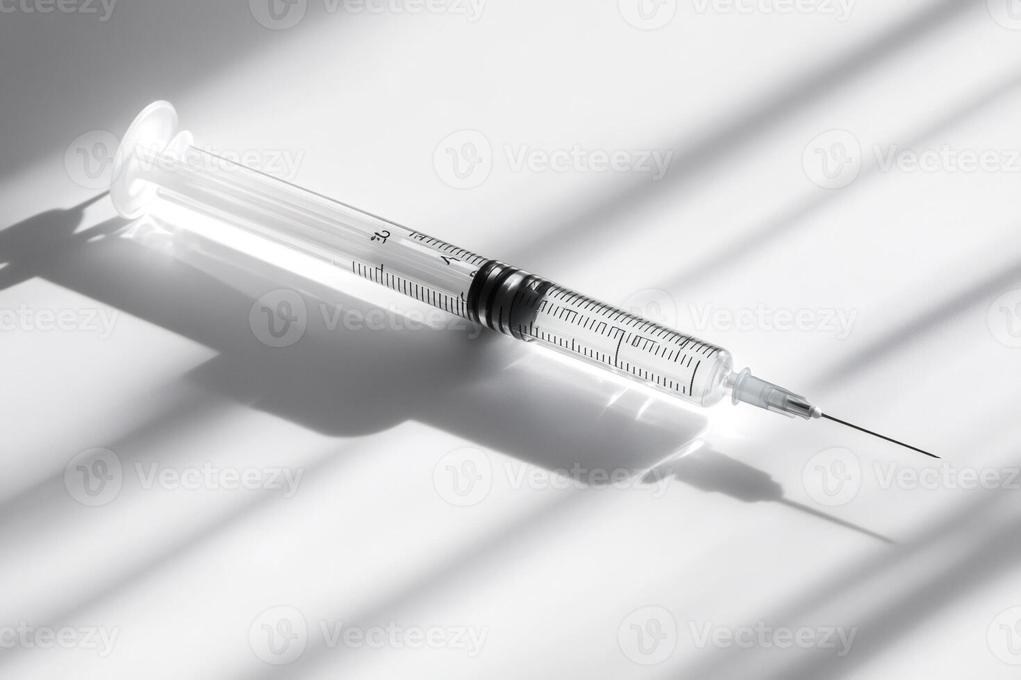 Medical syringe casting a shadow on white background photo
