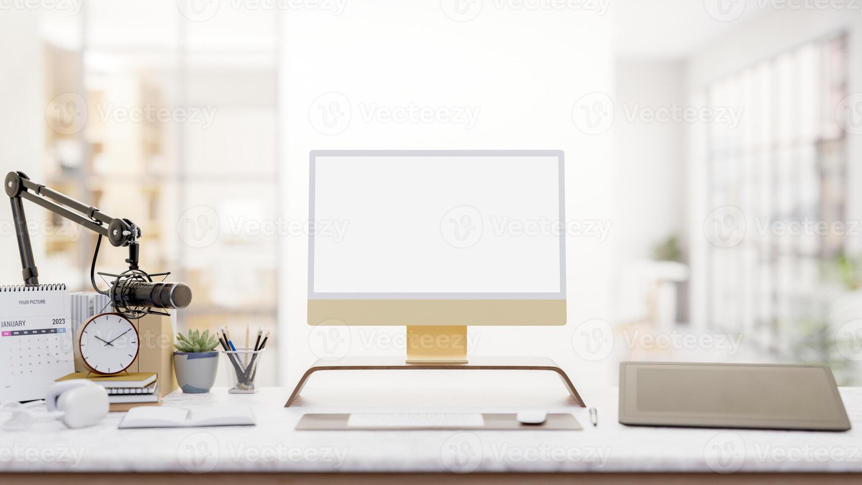 A modern podcaster office features a computer, a graphic tablet, and a microphone on a desk. photo