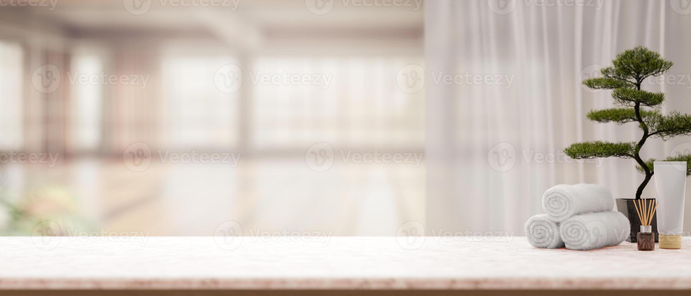 the white marble table with spa essentials and bonsai pot with blurry background of bright room. photo