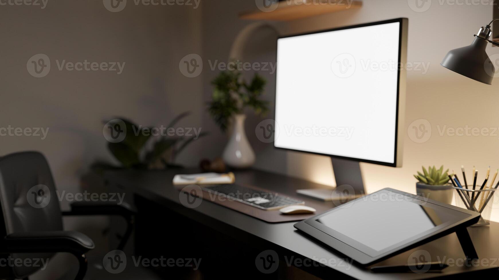 A side view of the white screen computer with graphic tablet and decorative items on wooden table. photo