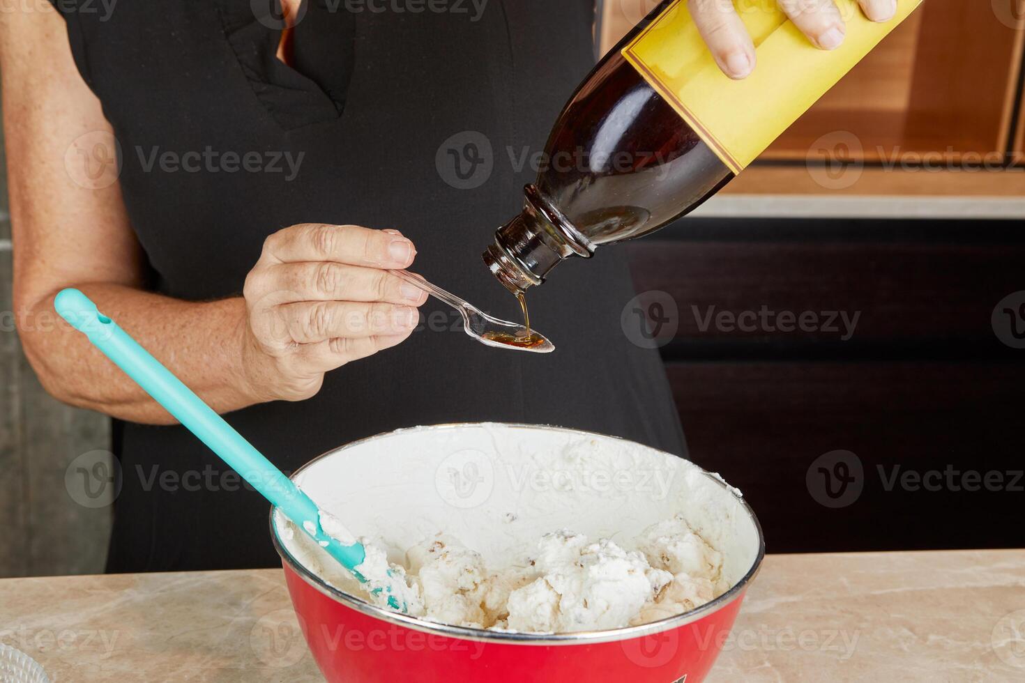 Layering a dessert with berries and whipped cream into glasses, preparing a visually appealing treat in the kitchen photo