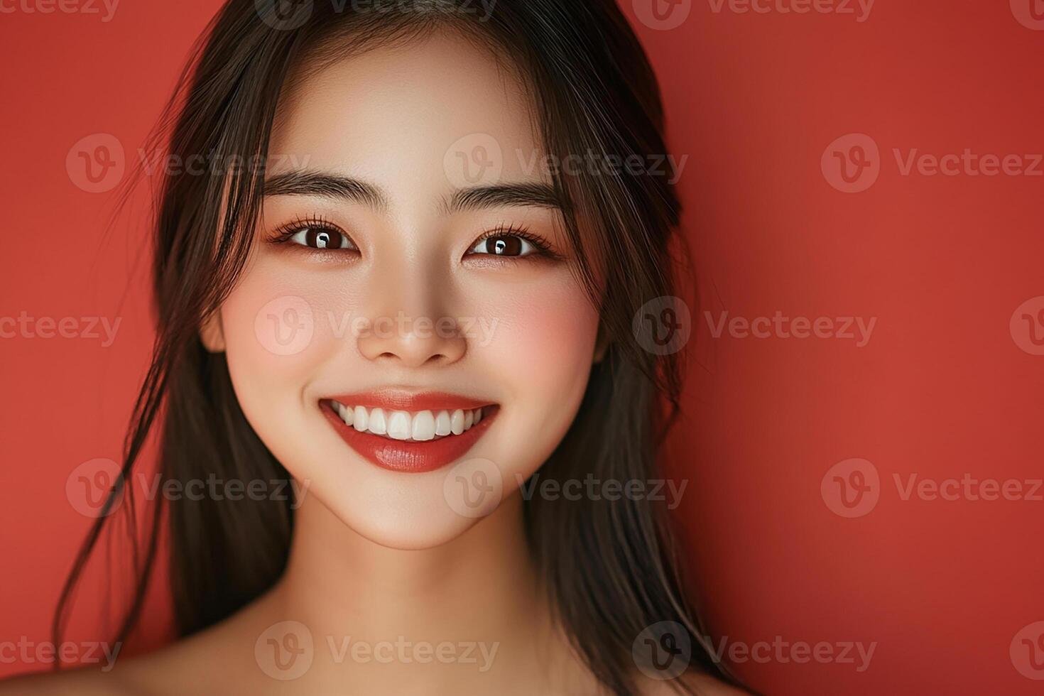 A beautiful woman with long black hair and a red background photo