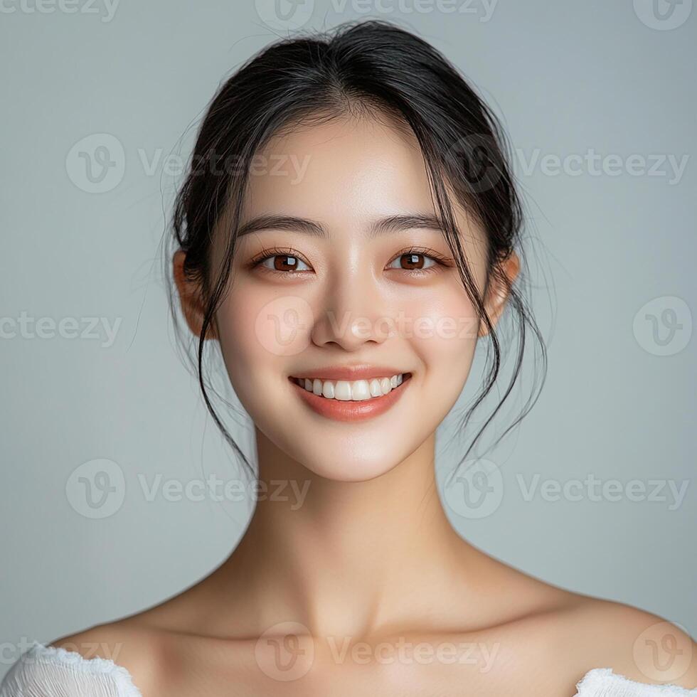 Beautiful asian woman smiling with her eyes closed photo