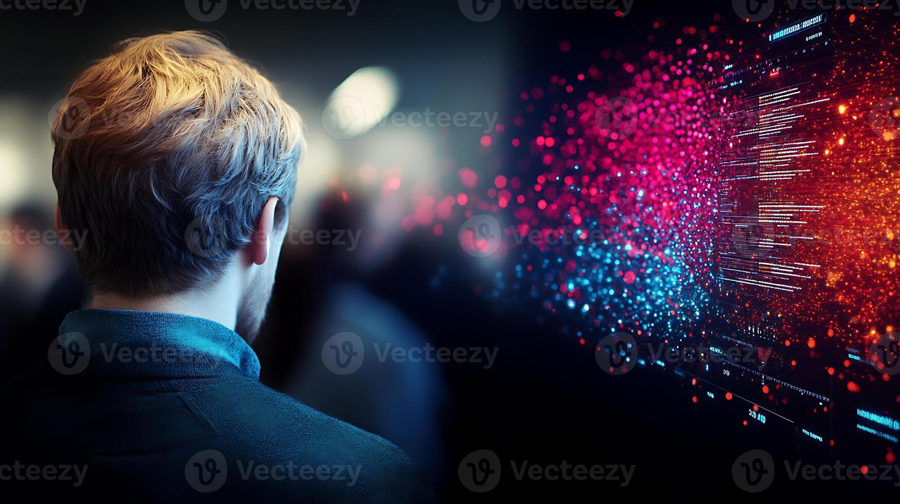 A person observing a vibrant digital display filled with data visualization in a crowded space photo