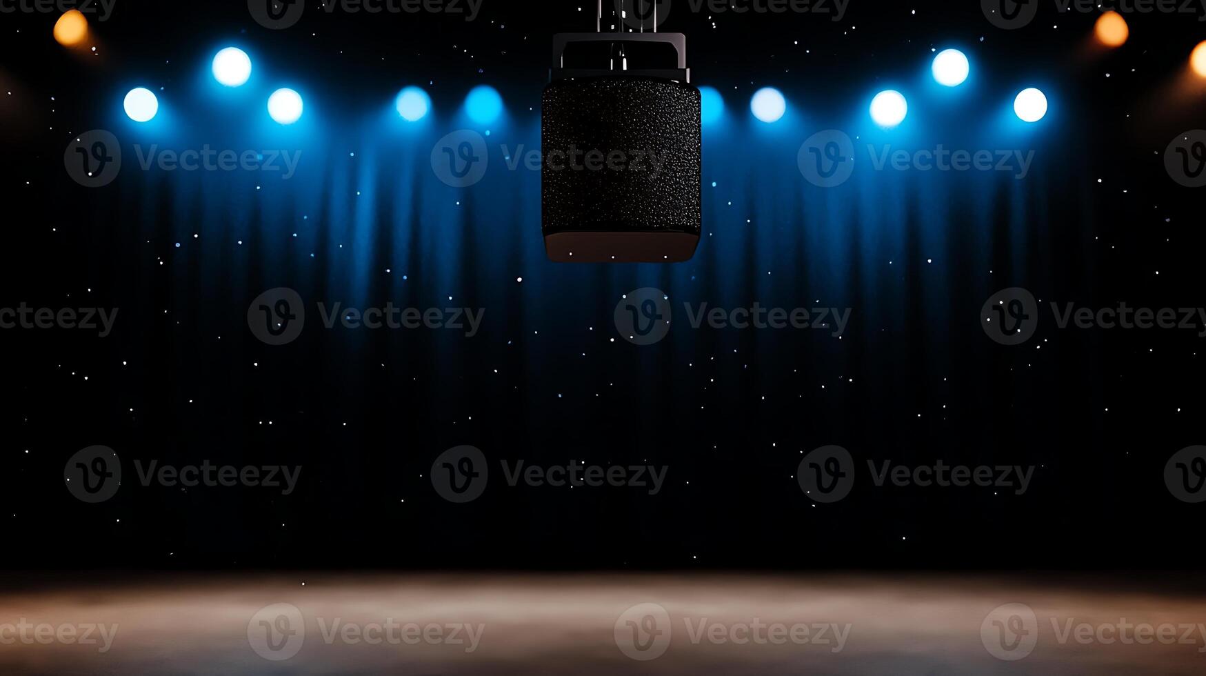 A spotlighted microphone hanging over an empty stage with colorful lights and a dark curtain backdrop photo