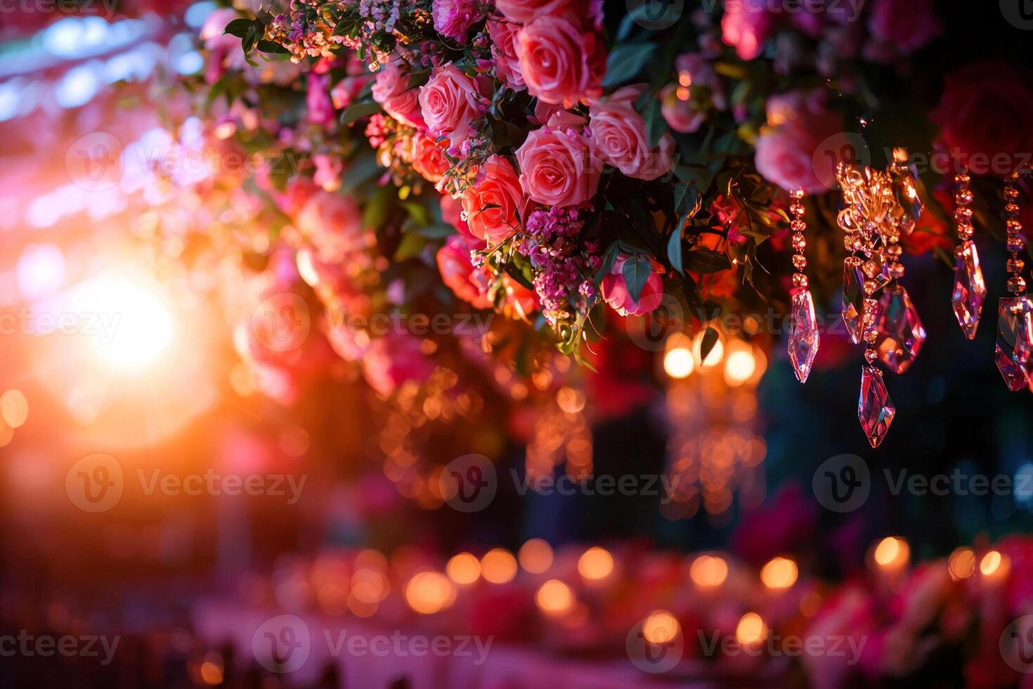 breathtaking floral chandelier adorned fresh roses and greenery hangs above beautifully set garden table. Crystal ornaments catch light creating magical atmosphere photo