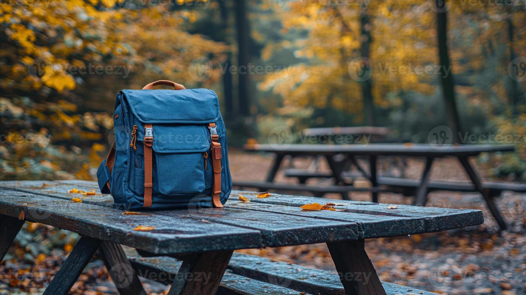 flat design mockup showcases customizable backpack resting on picnic table surrounded greenery in sunny park. Perfect for branding opportunities and outdoor promotions photo