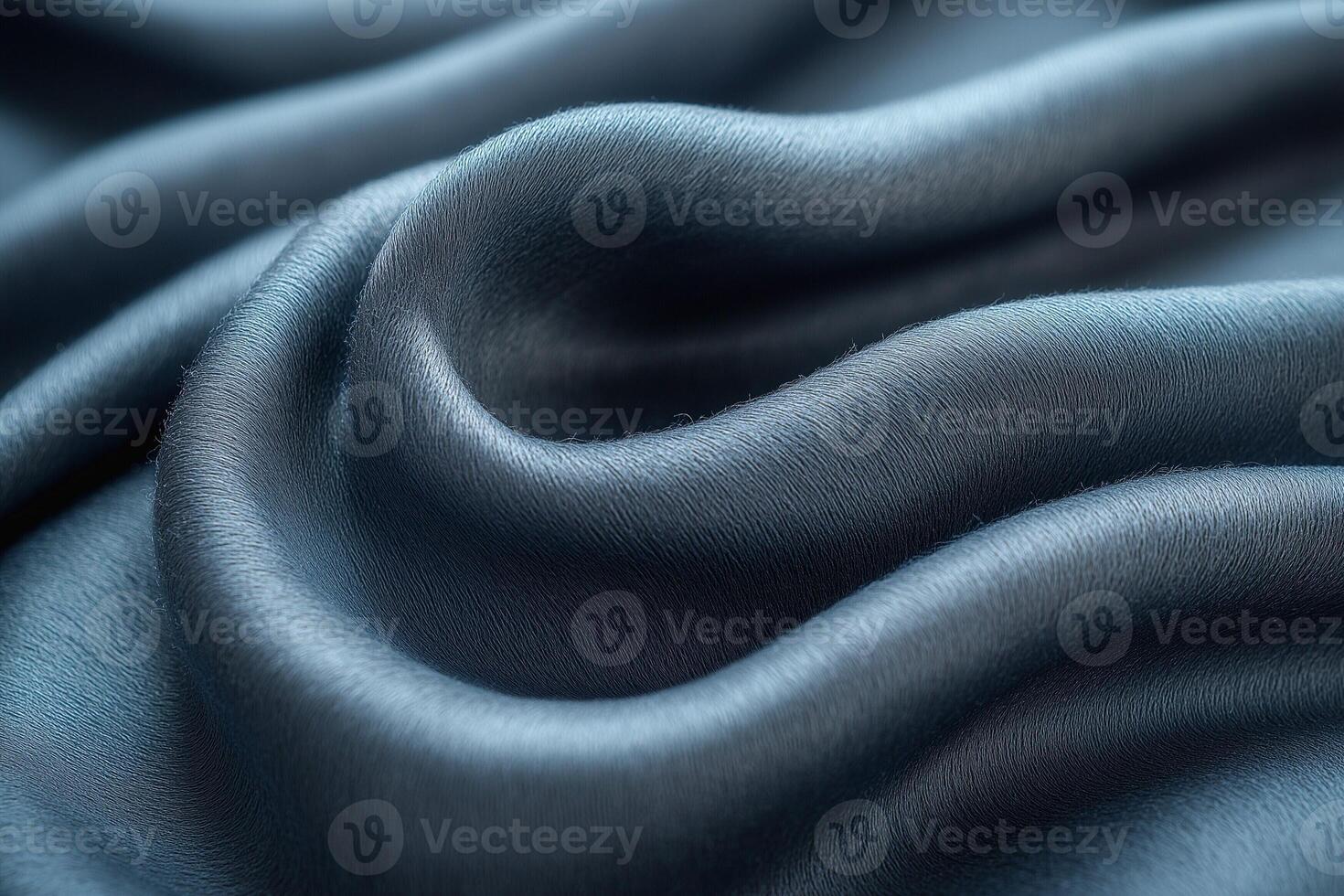 Close-up of luxurious, dark blue satin fabric with smooth, flowing curves. photo