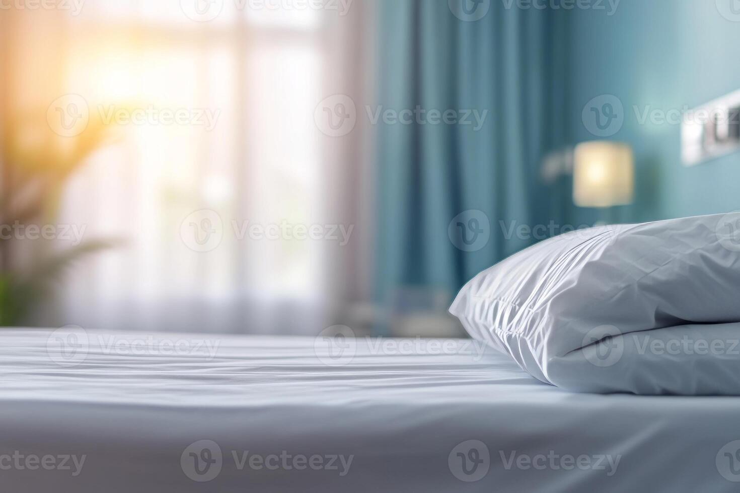 A soft white pillow resting on a neatly made bed in a serene bedroom setting with gentle sunlight streaming through the window. photo