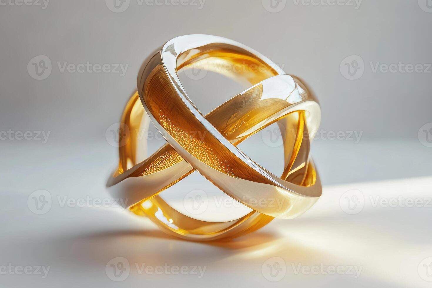 An elegant interwoven sculpture featuring shiny gold and silver tones, showcasing modern design and craftsmanship. photo