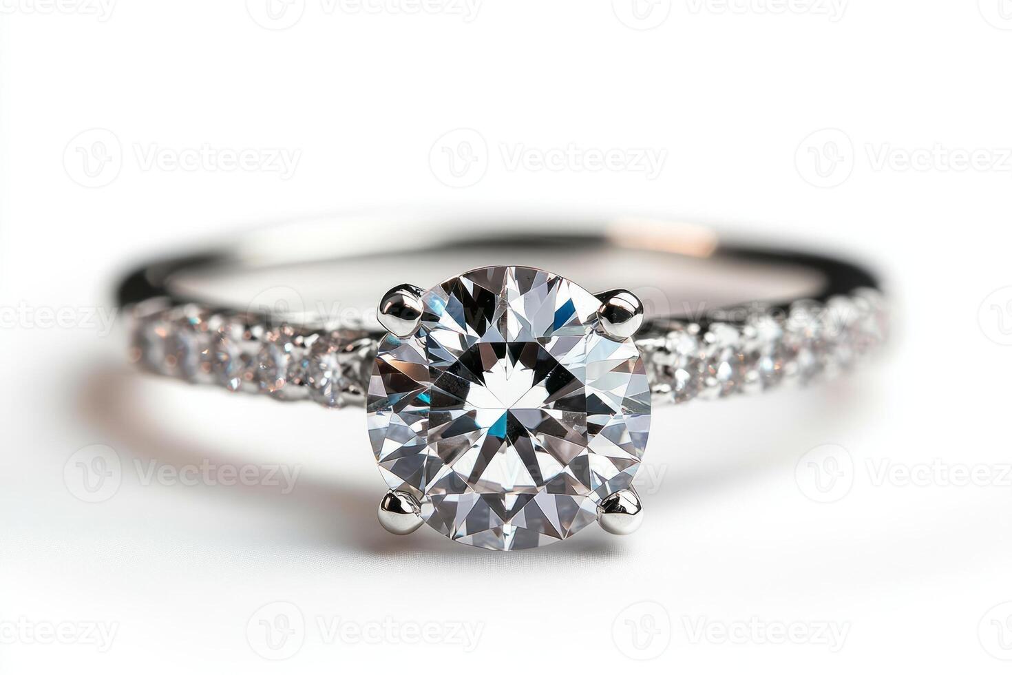 An exquisite silver engagement ring featuring a brilliant round-cut diamond center stone, surrounded by sparkling smaller diamonds. photo