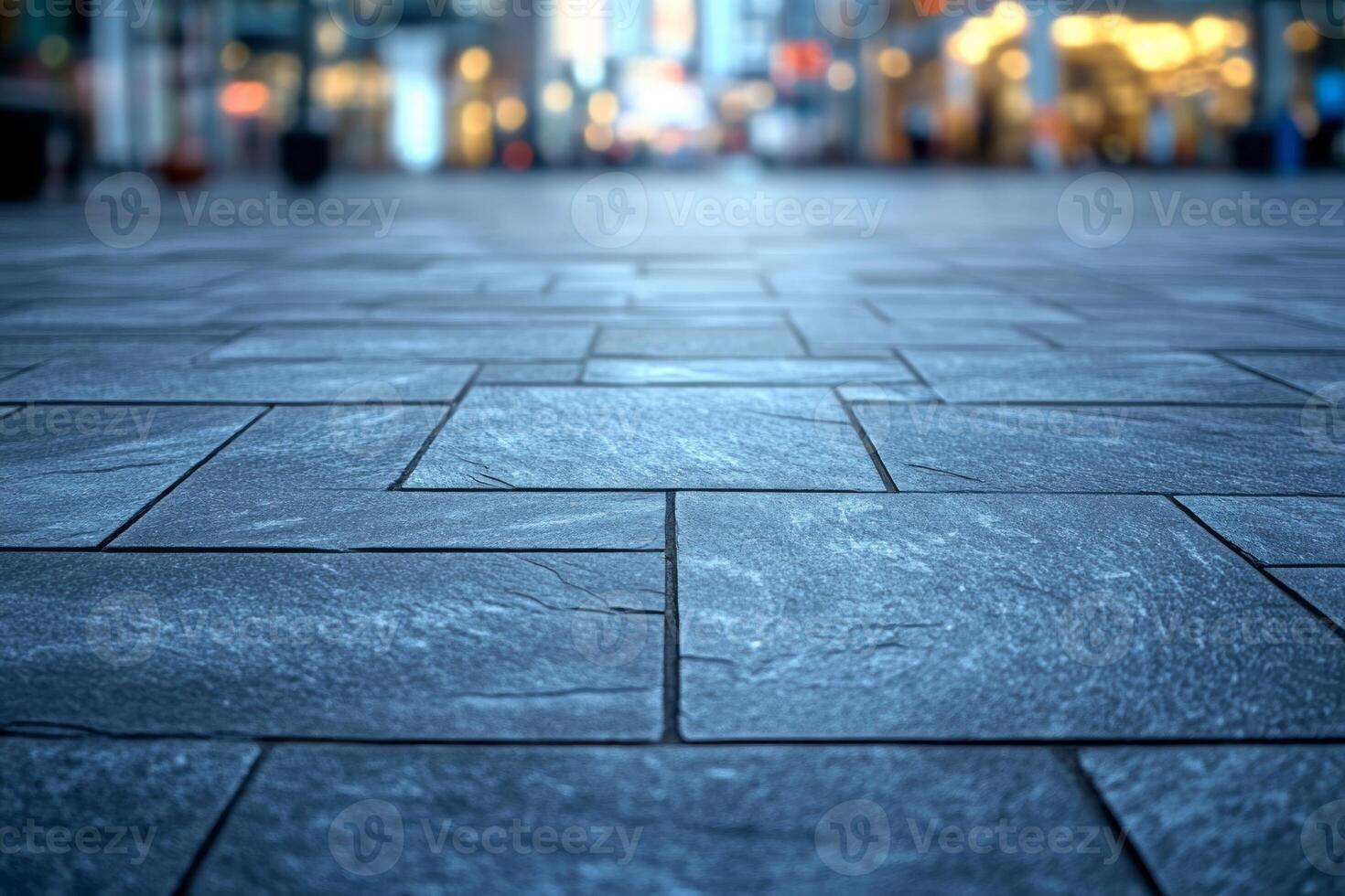 A close-up view of a textured stone pavement in a bustling urban setting, conveying a modern and inviting atmosphere. photo