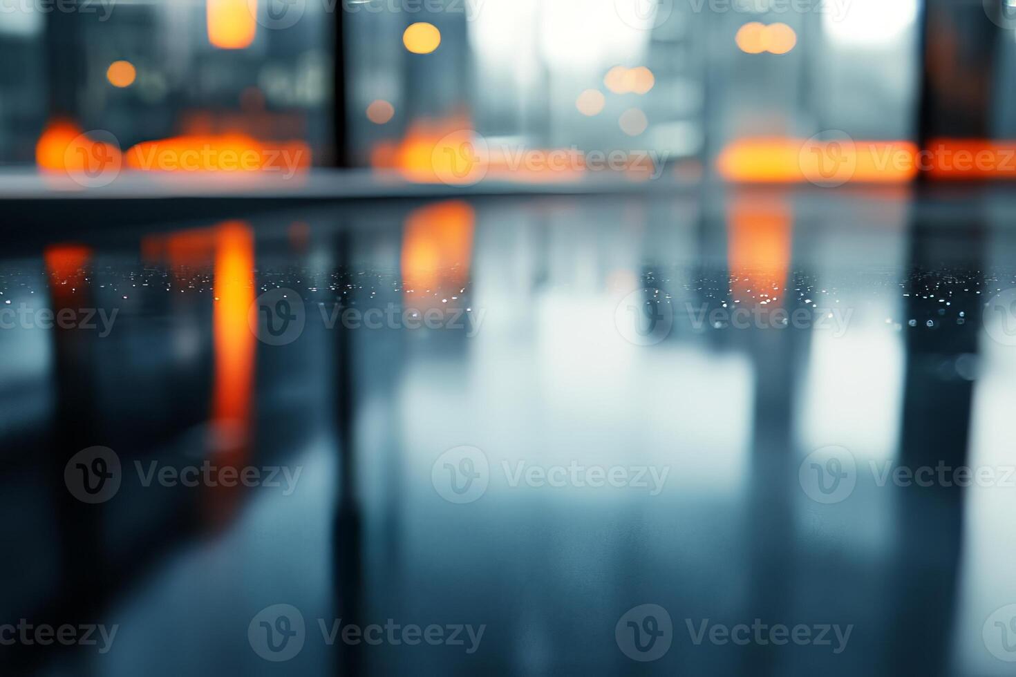 An abstract view capturing droplets on a glossy surface, with warm orange hues reflecting in a modern indoor setting. photo