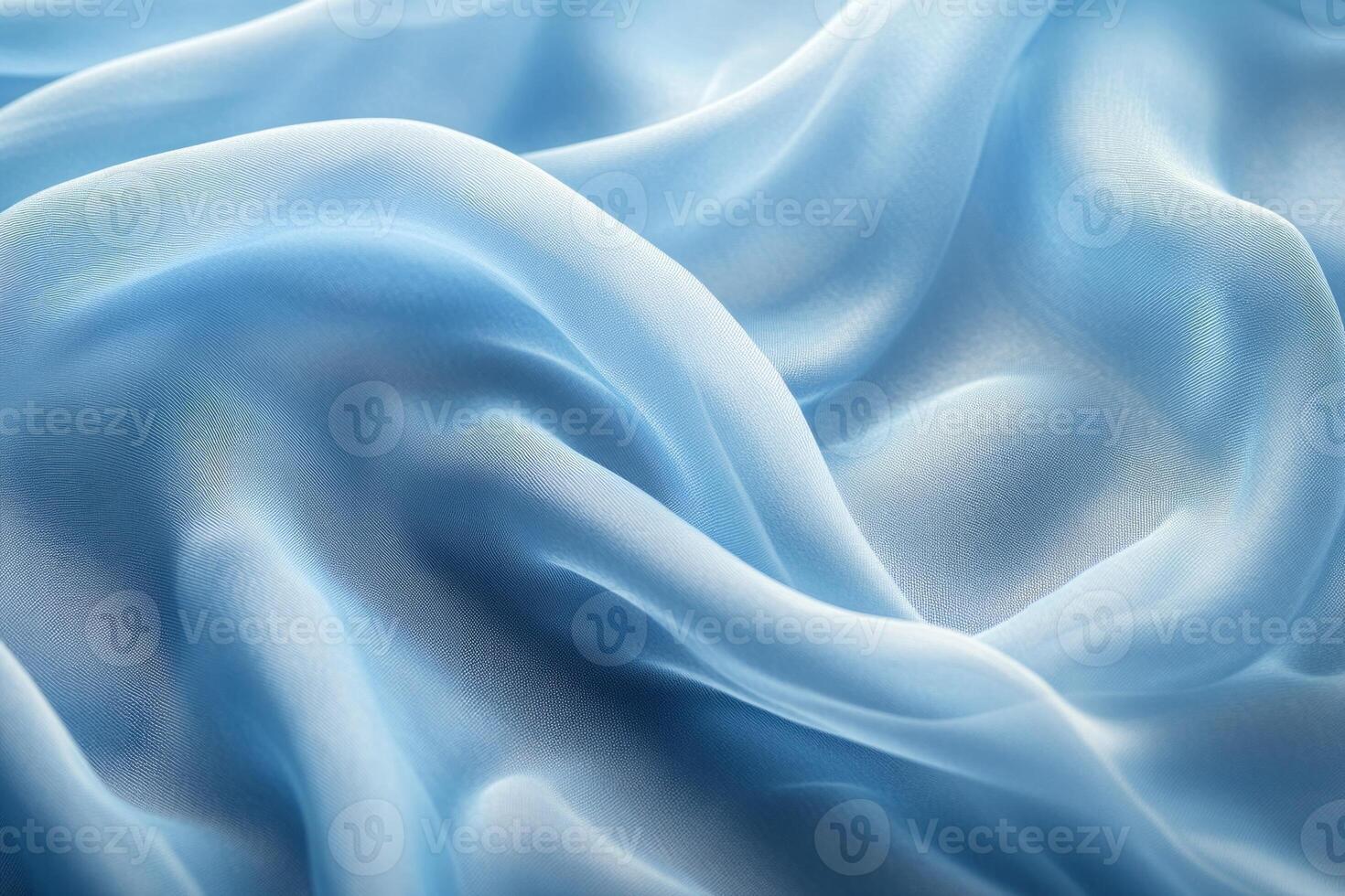Delicate light blue silk fabric with soft folds and waves, creating a serene and elegant texture. photo