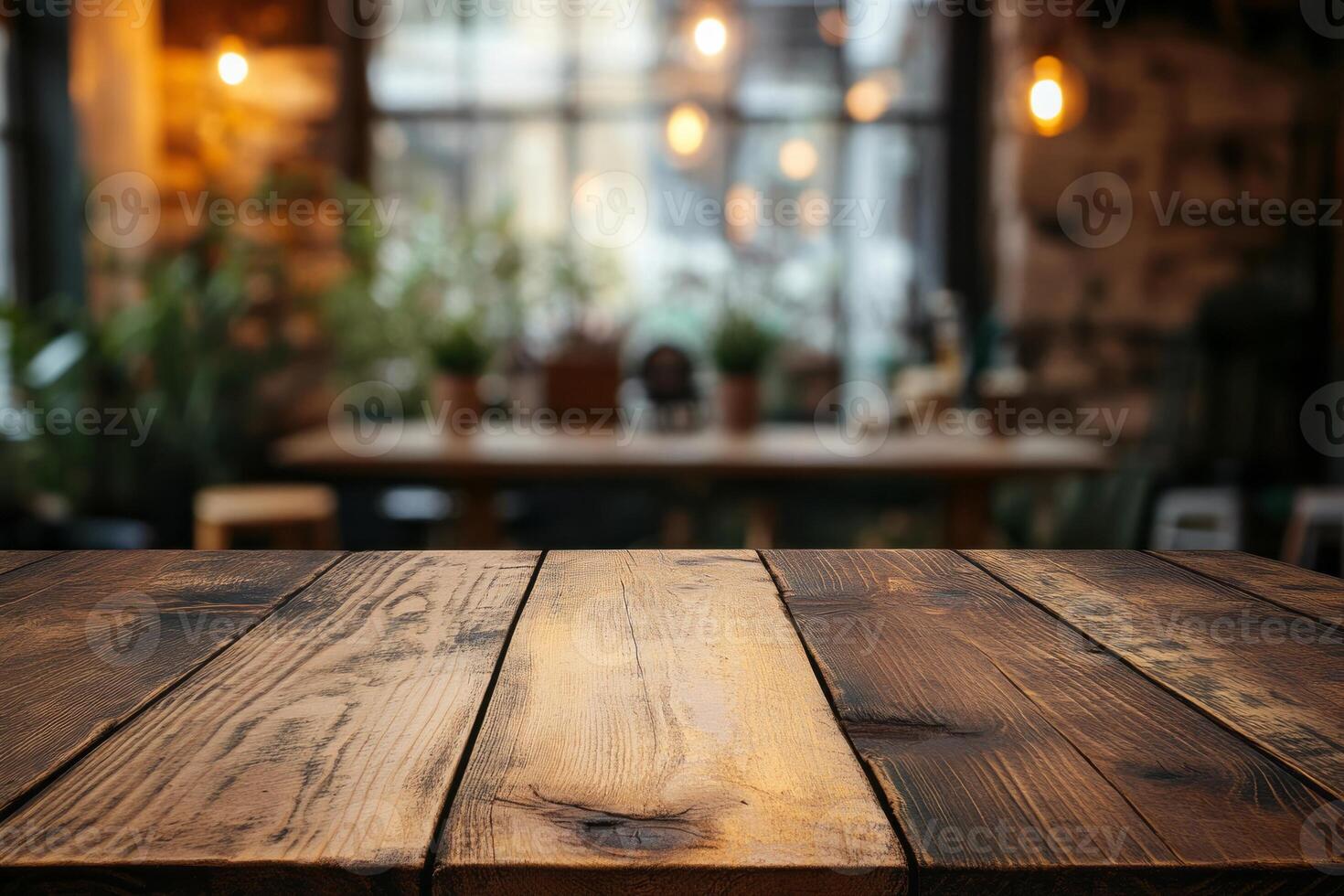 Warm wooden table in a cozy cafe setting with soft lighting and plants in the background. photo