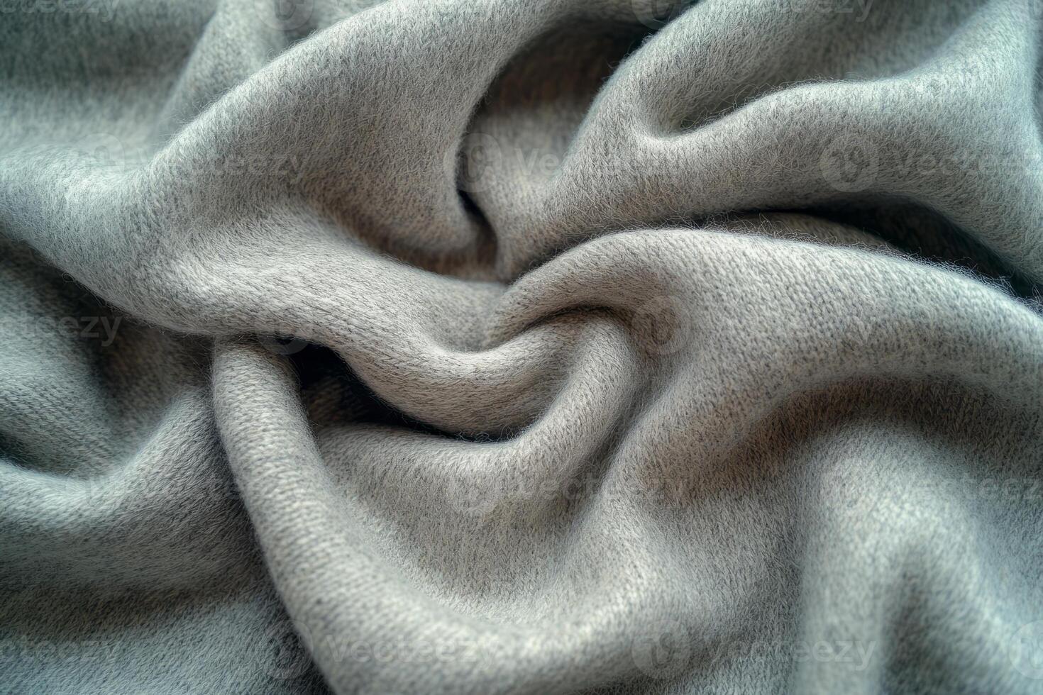 Close-up of soft, luxurious grey fabric, showcasing its smooth texture and intricate folds. photo