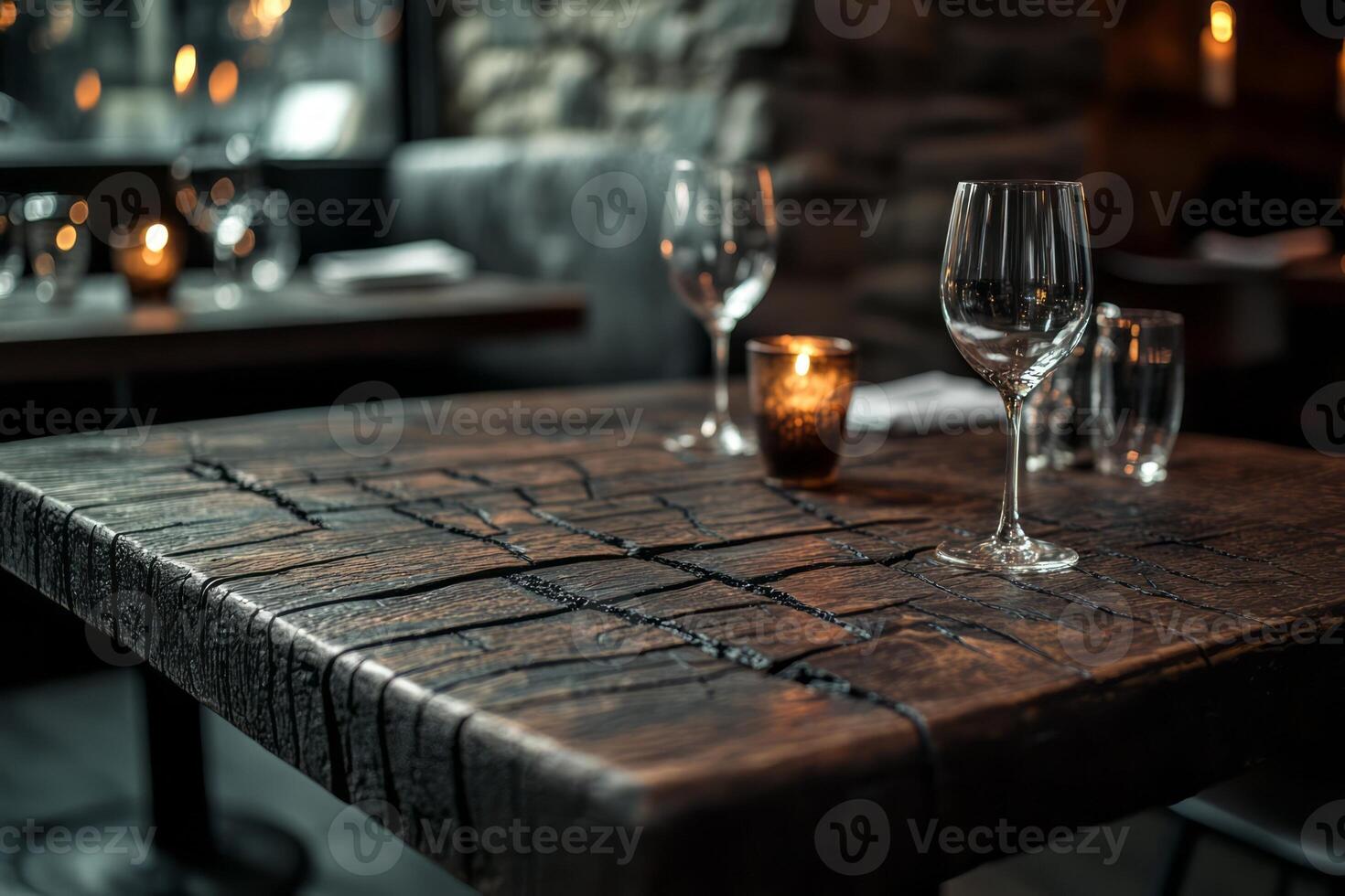 Elegant dining setup with polished glasses on a rustic wooden table, creating a cozy atmosphere in a dimly lit restaurant. photo