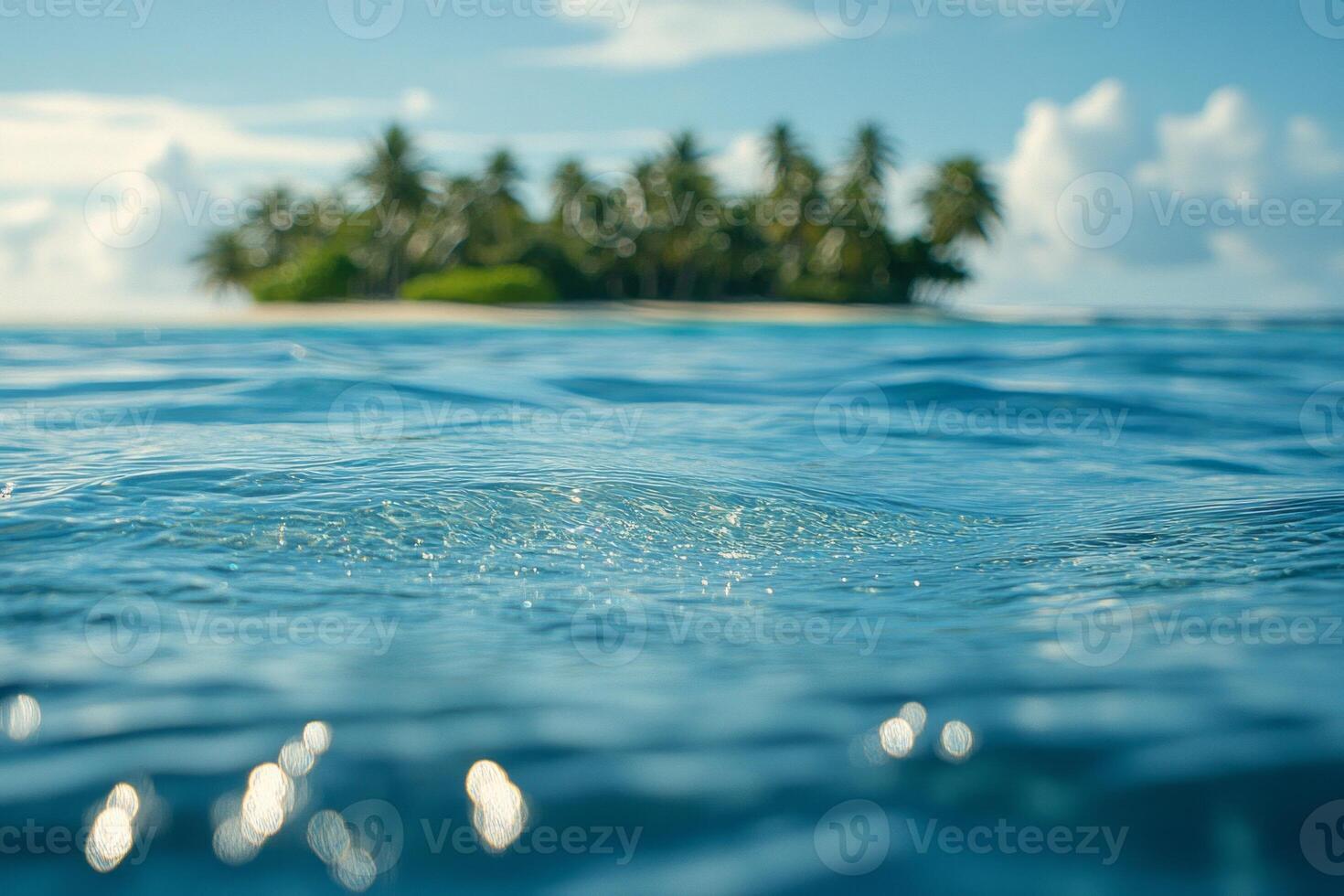 A tranquil view of sparkling ocean water with a distant tropical island in the background. Perfect for a serene getaway. photo