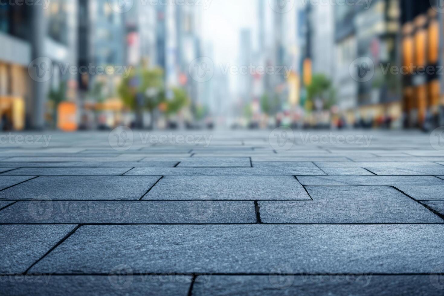 A serene view of a city street with modern buildings, captured from a low perspective, showcasing detailed pavement patterns. photo