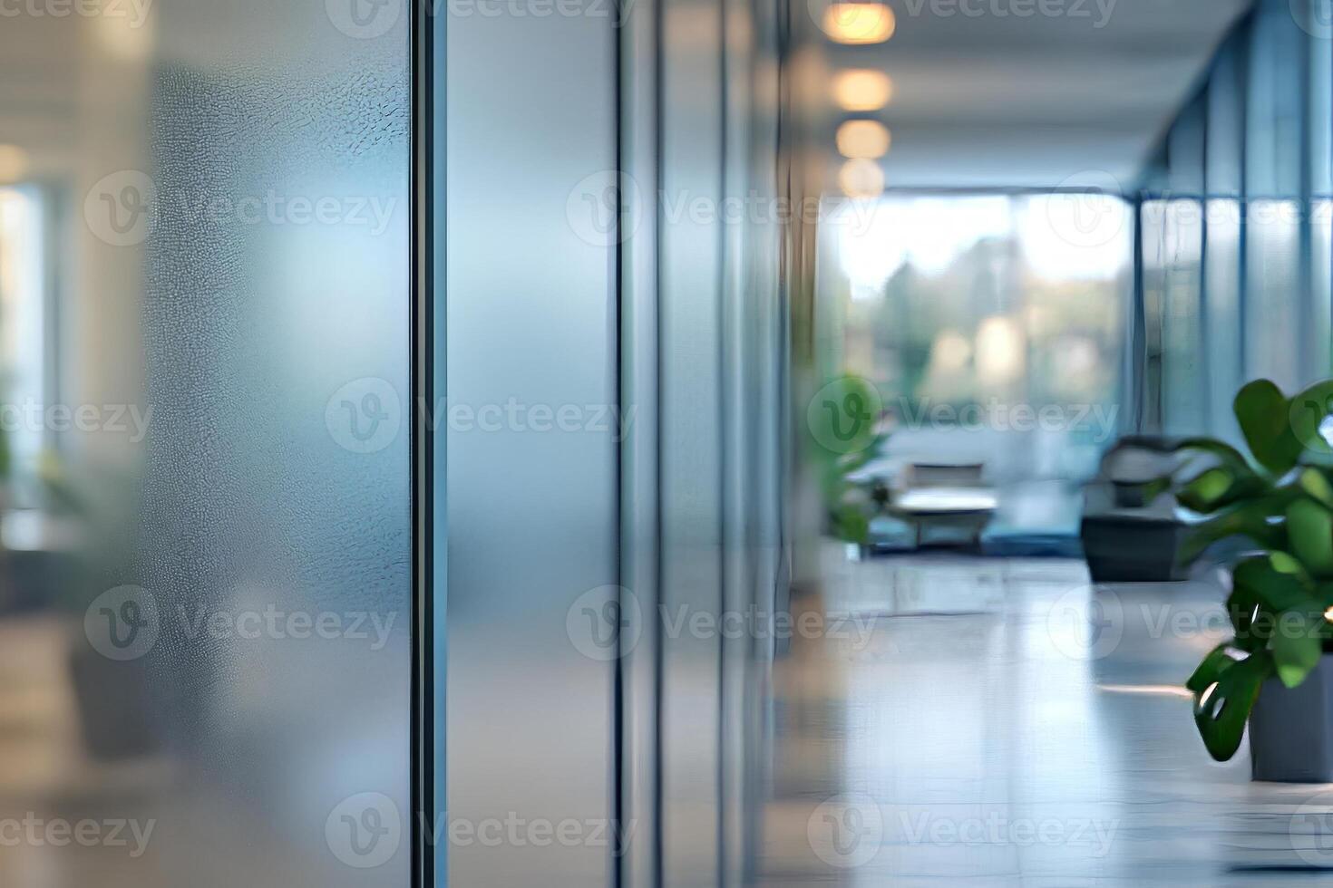 A tranquil office corridor with blurred glass partitions and lush green plants, creating a serene workplace atmosphere. photo