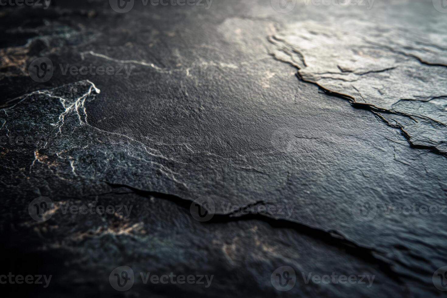 Close-up of dark textured stone surface with intricate patterns and natural veining, showcasing rugged beauty. photo