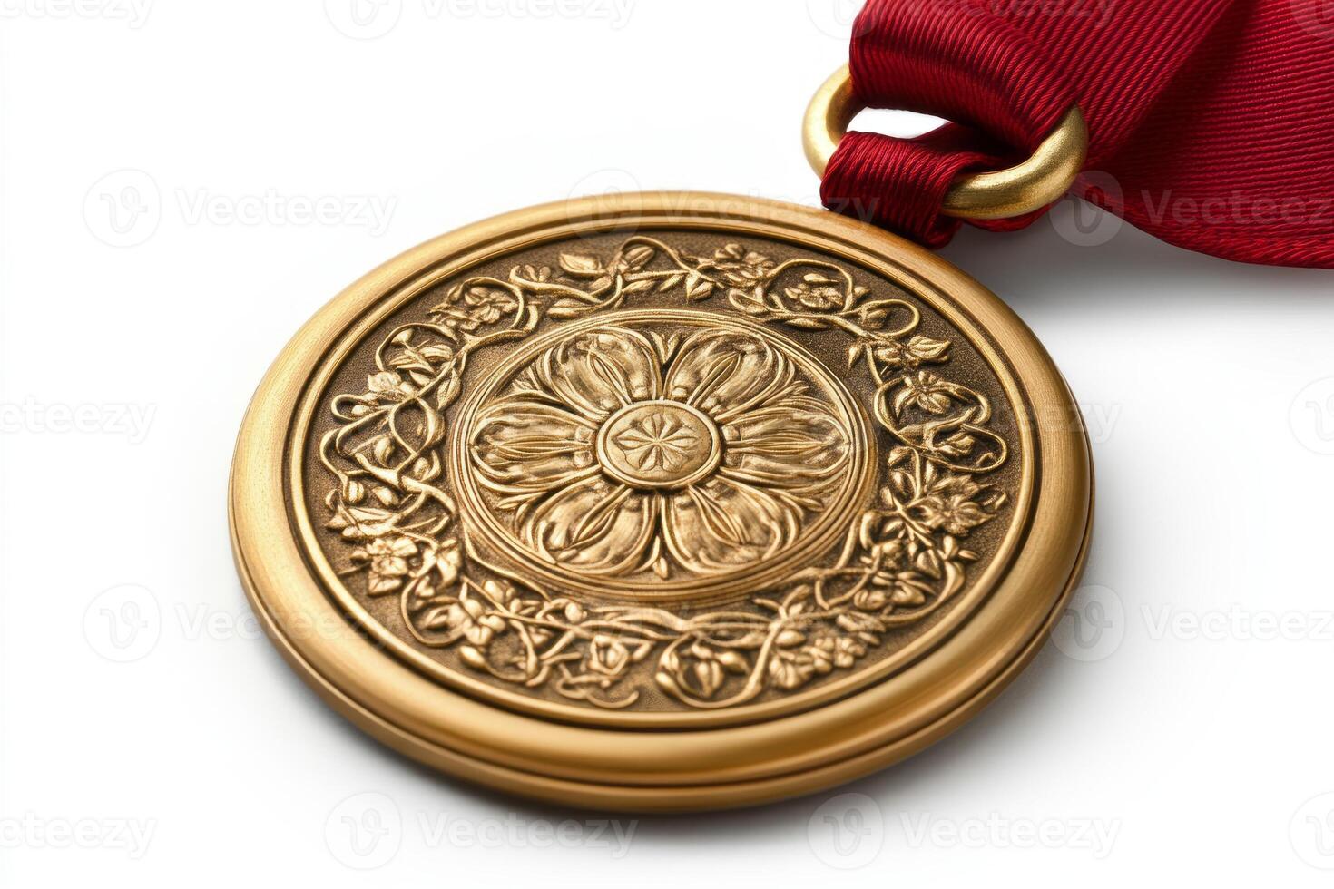 A beautifully designed gold medal with an intricate floral pattern and a red ribbon, symbolizing achievement and excellence. photo