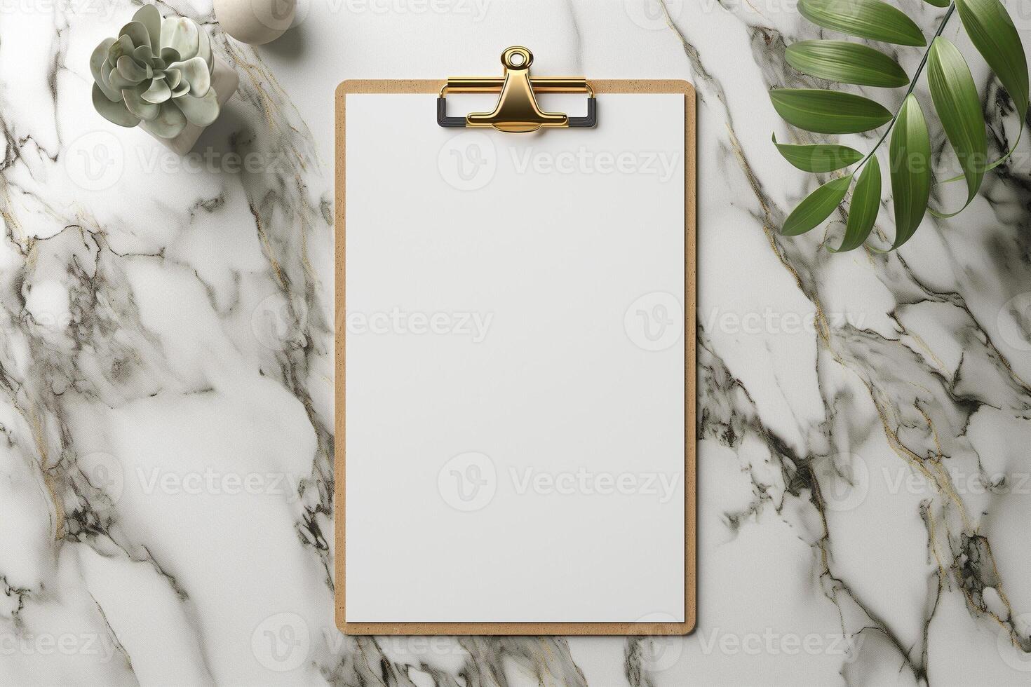 A blank clipboard on a marble surface surrounded by a plant and decorative elements. photo