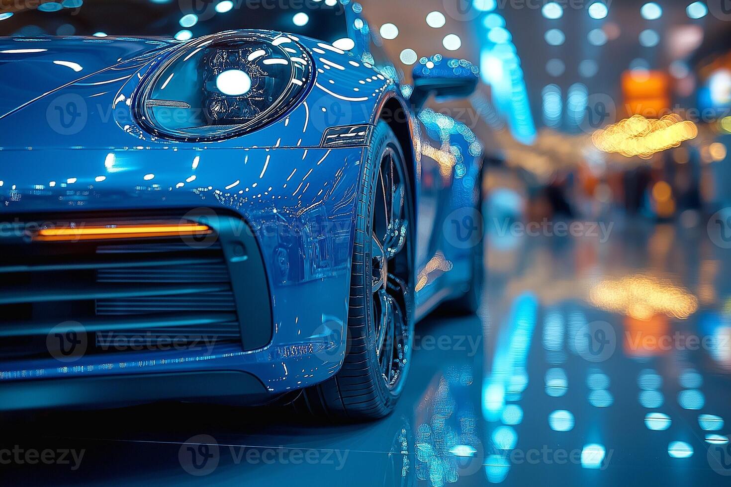 Close-up of a sleek blue sports car showcasing its glossy finish and modern design under vibrant showroom lights. photo