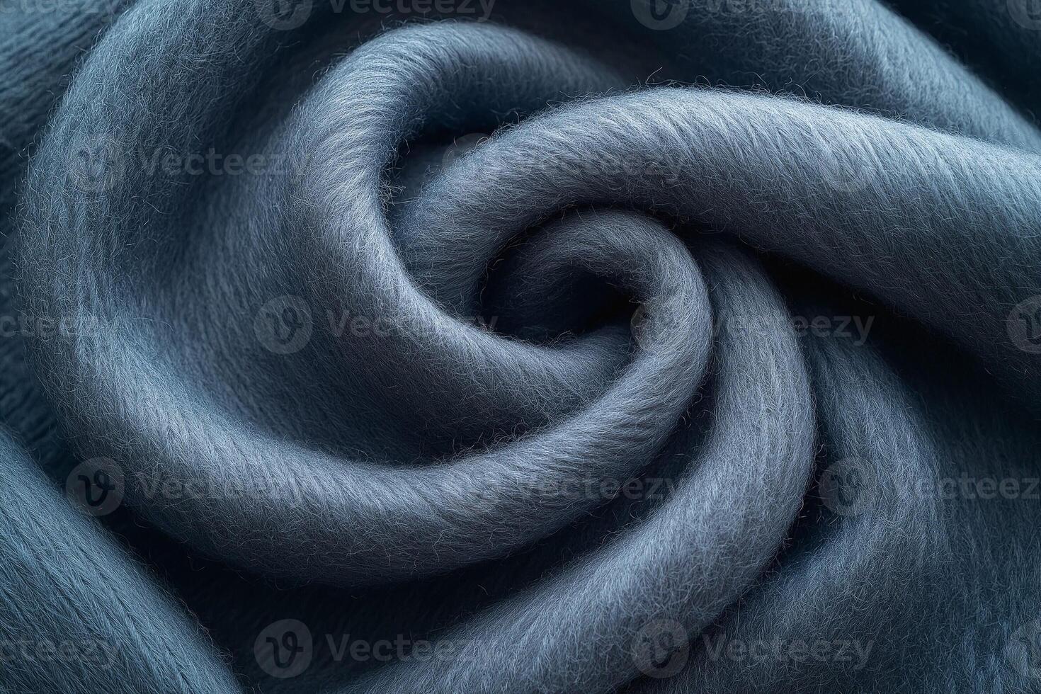 Close-up of soft, swirling blue fabric, showcasing its texture and luxurious feel. photo