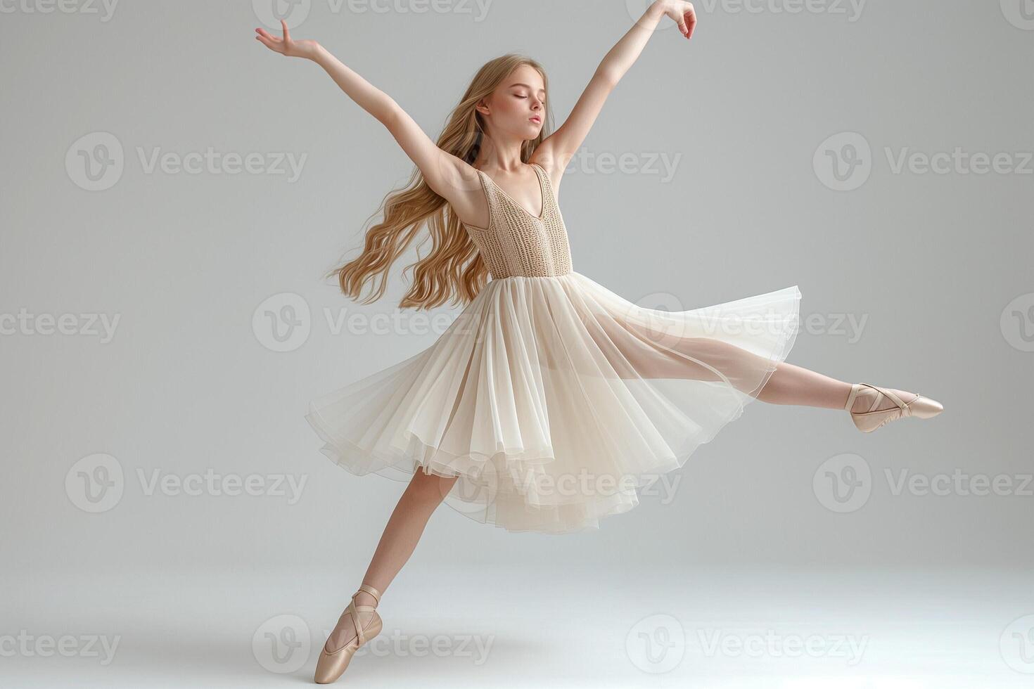A graceful young Caucasian ballet dancer performs an elegant leap in a flowing ivory dress, showcasing her passion and poise. photo