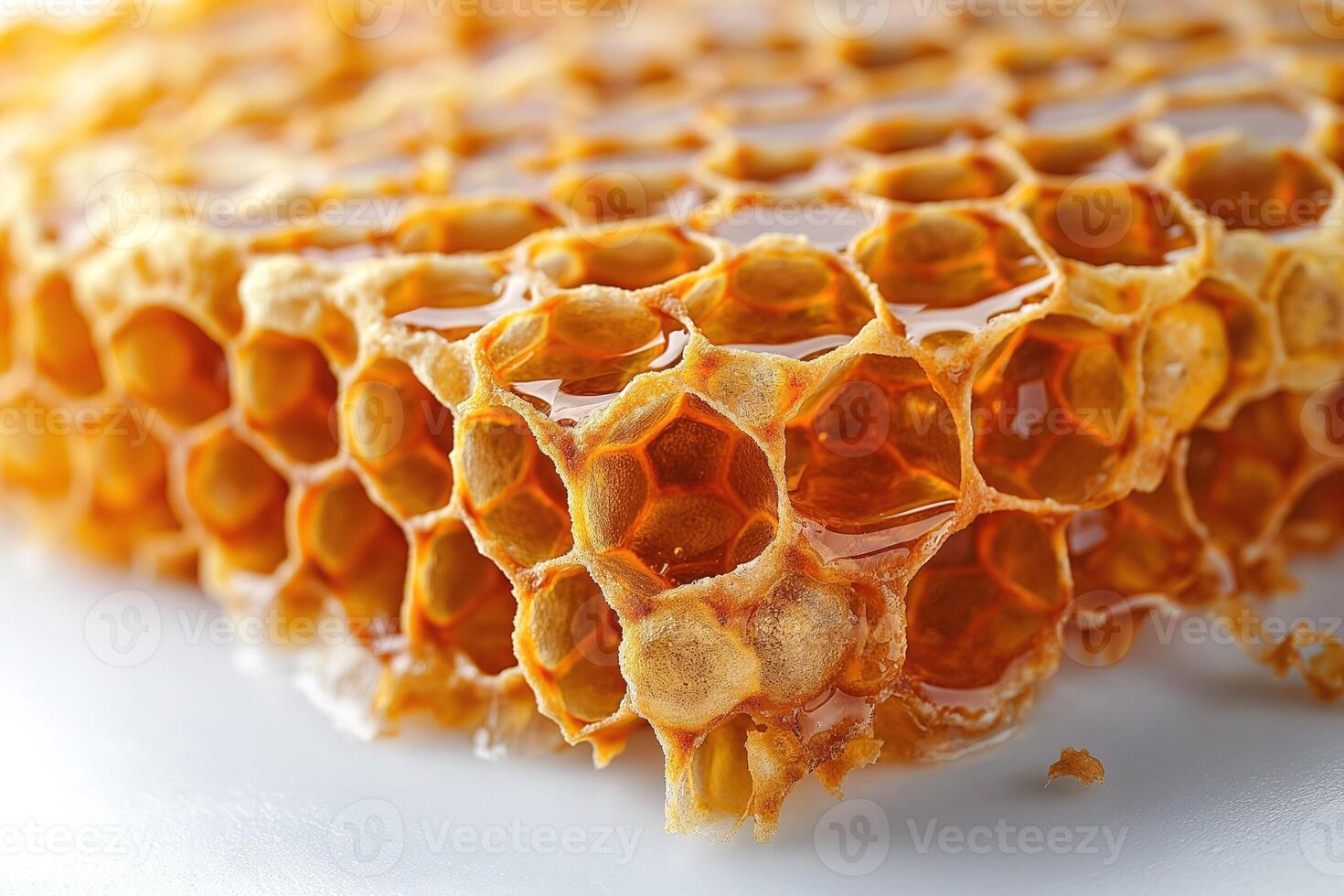 Close-up of golden honeycomb dripping with rich, sweet honey, showcasing its intricate hexagonal structure. photo
