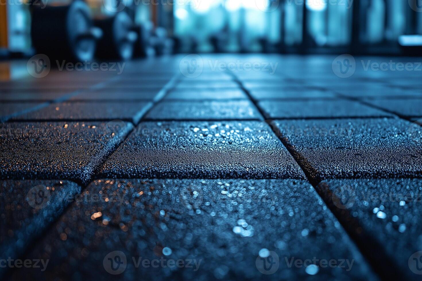 Close-up of wet gym floor, reflecting light, creating a dramatic and motivating atmosphere for fitness enthusiasts. photo