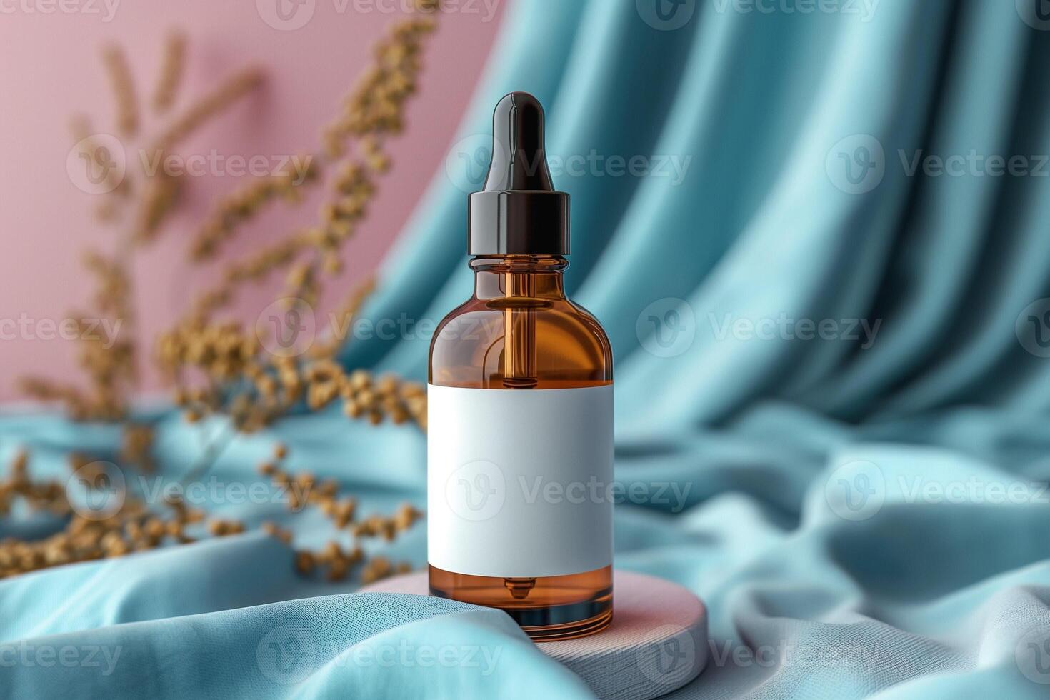 Amber glass bottle with dropper on soft teal fabric, surrounded by dried foliage, creating a serene and elegant atmosphere. photo