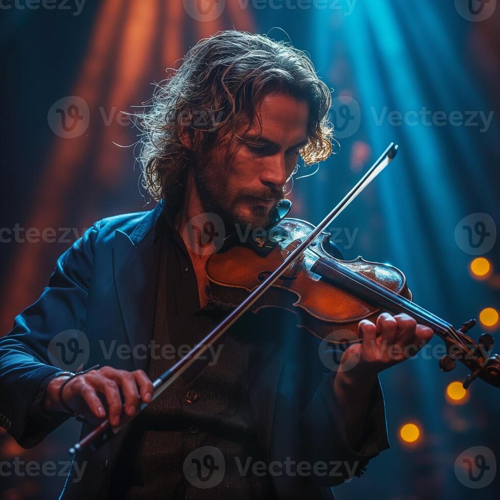 A focused male musician of Middle-Eastern descent captivates the audience while playing the violin on stage under dramatic lighting. photo