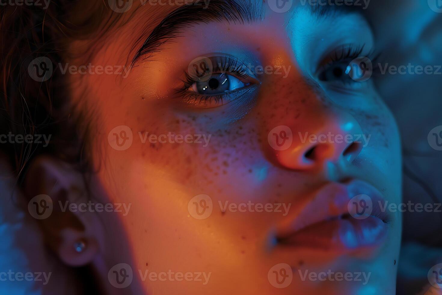 A woman with freckles on her face is looking up photo