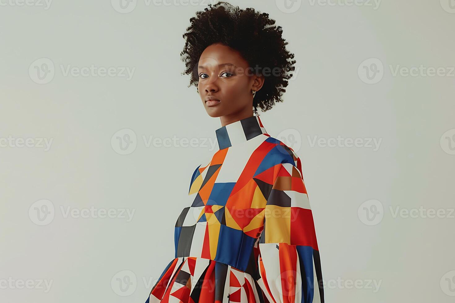 A model wears a colorful dress with geometric patterns photo