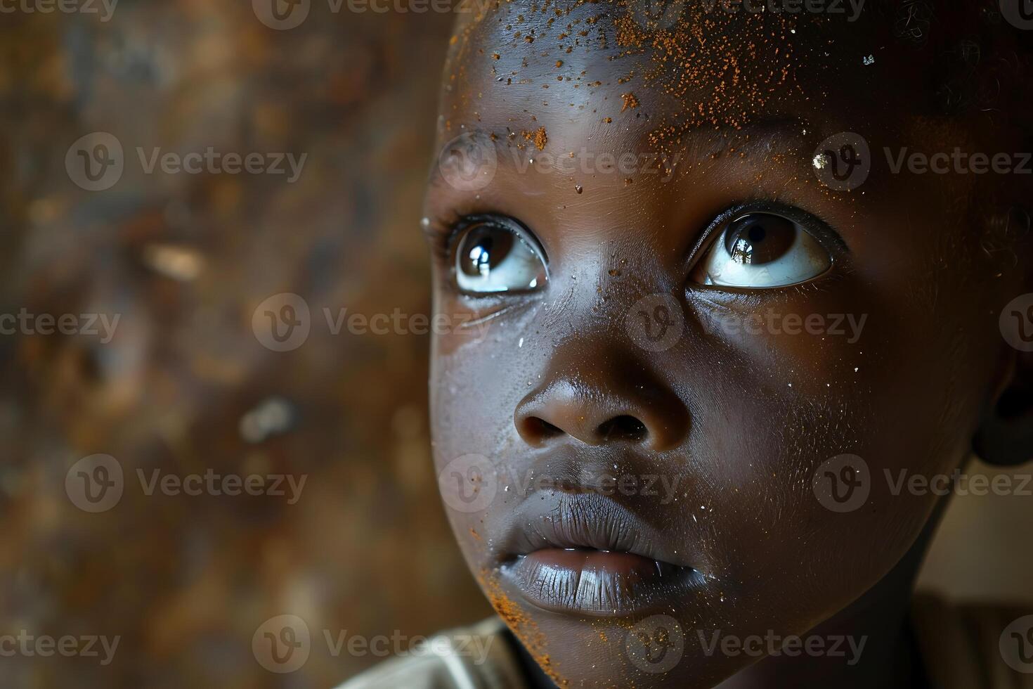 A young boy looks up at the camera photo