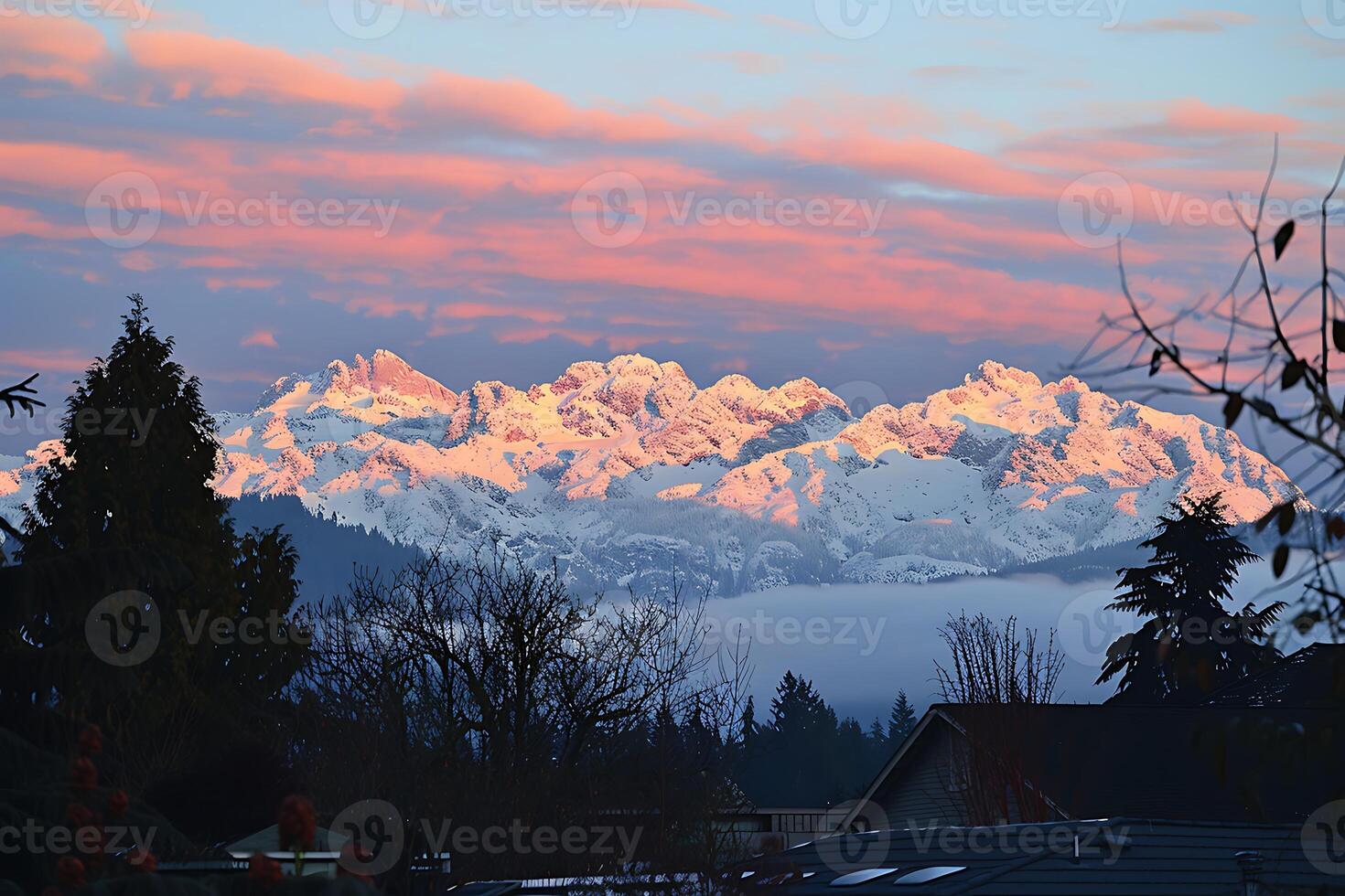 A view of a snowy mountain range from a house photo