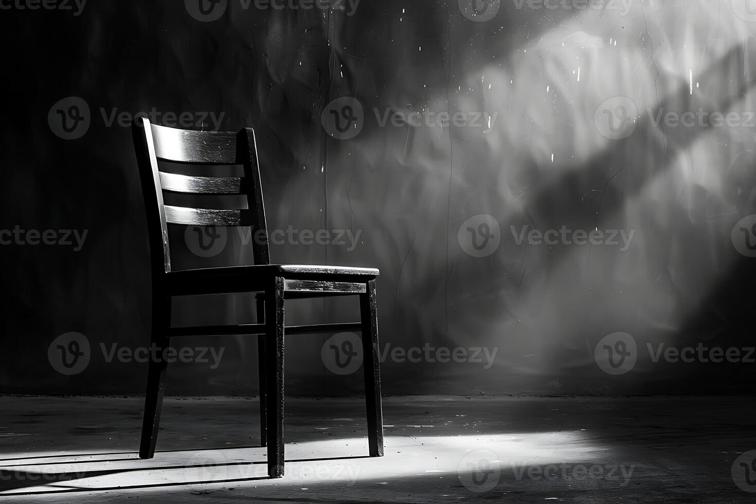 A chair in a dark room with sunlight shining through the window photo