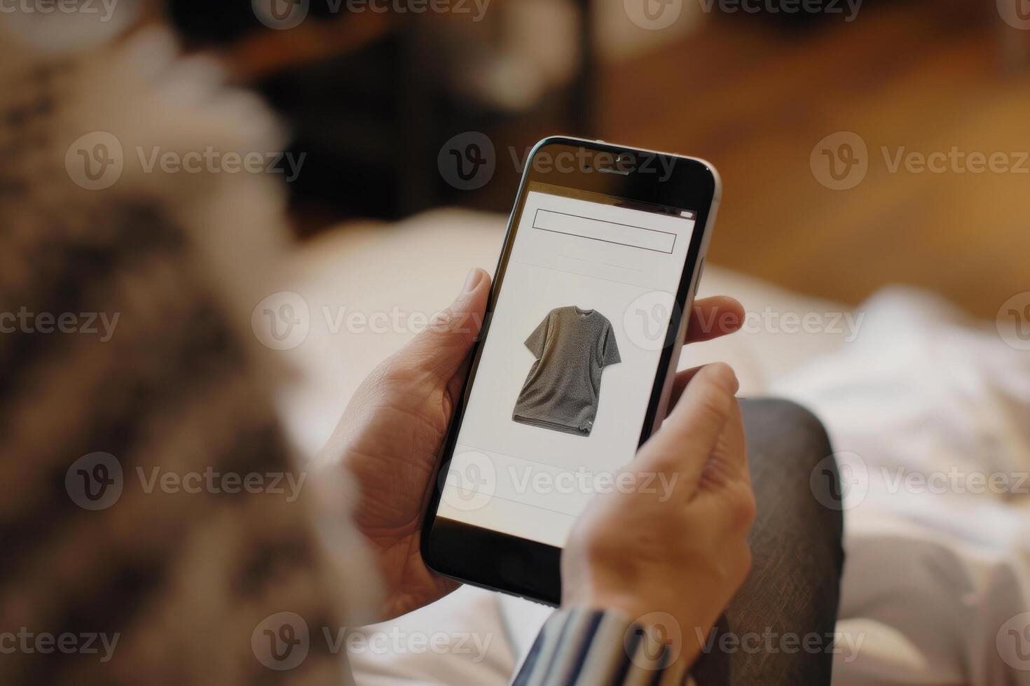 A person browsing an online shopping app for a t-shirt on smartphone photo