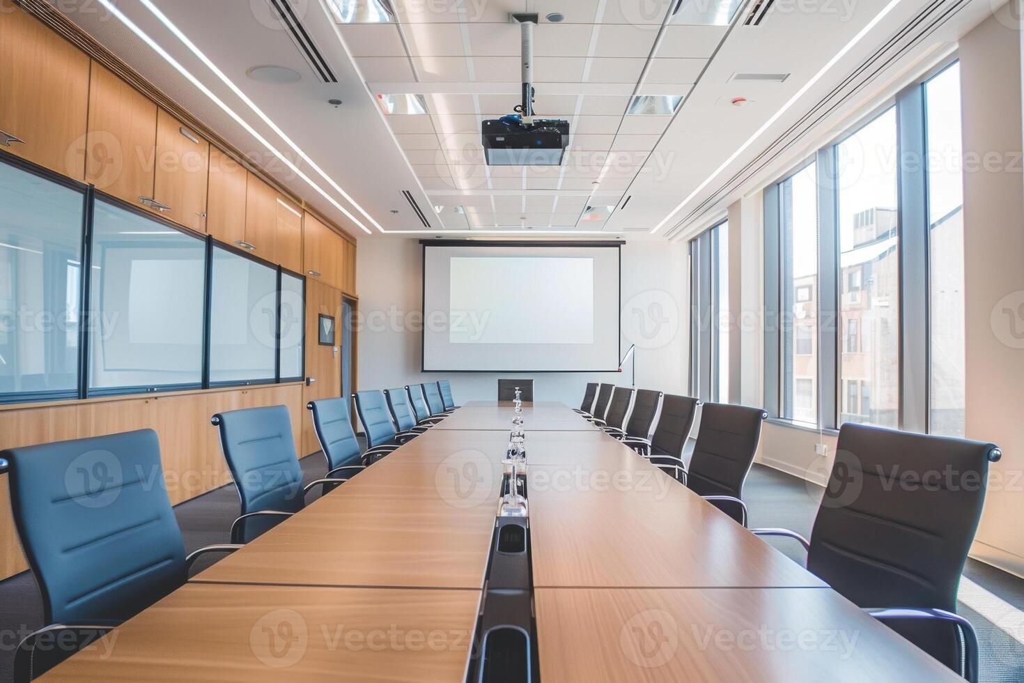 conference room with a long table, chairs, and a projector screen photo