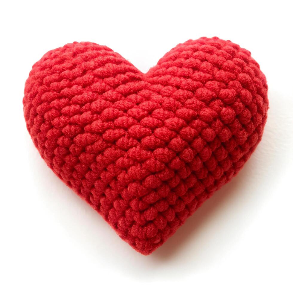 Large red crocheted heart on white background photo